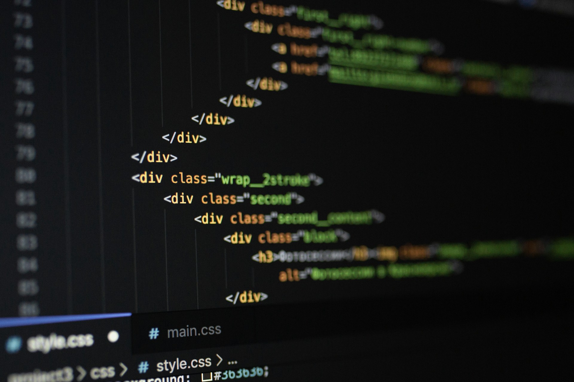 HTML and CSS code displayed on a dark computer screen showing div elements with class names and styling attributes.